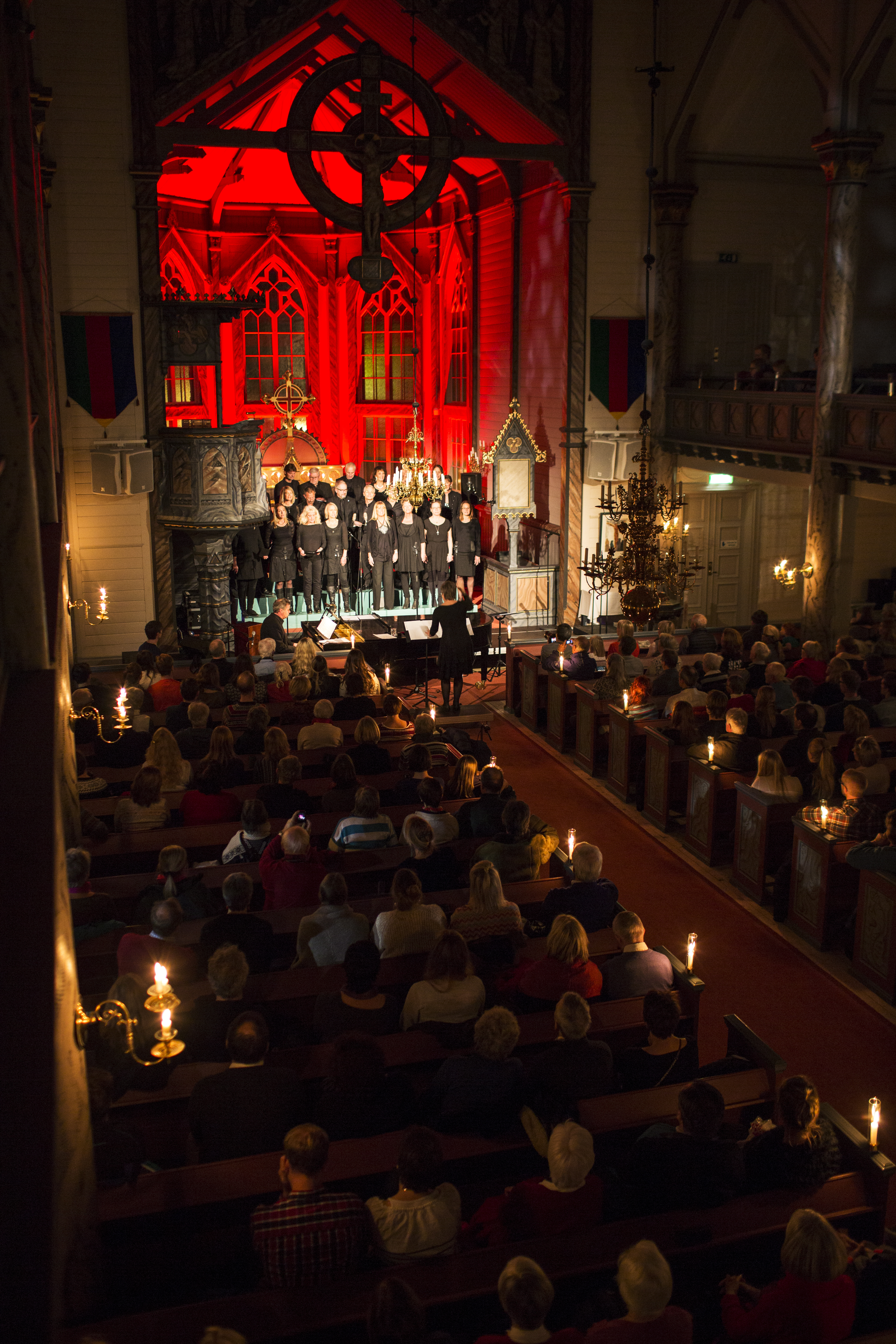 En kör uppträder inför en fullsatt kyrka.